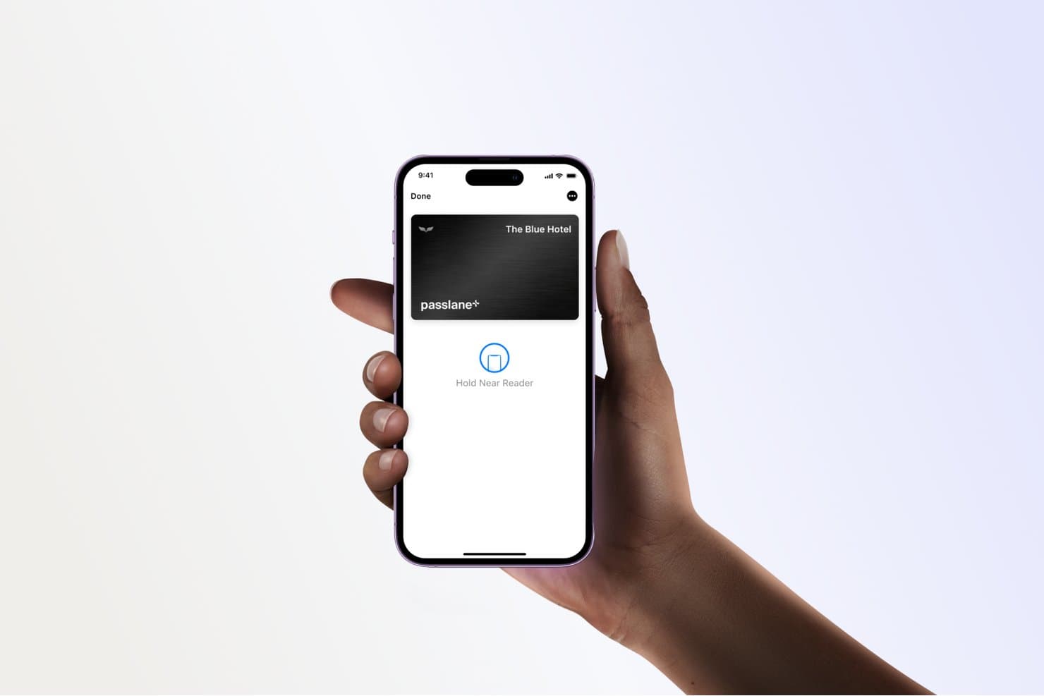 Hand holding iPhone displaying a digital hotel key card with Hold Near Reader prompt.