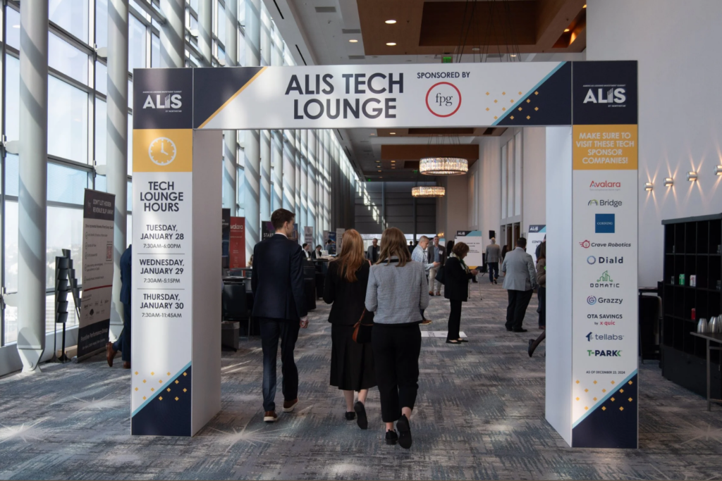 Attendees walking through the ALIS Conference Tech Lounge area