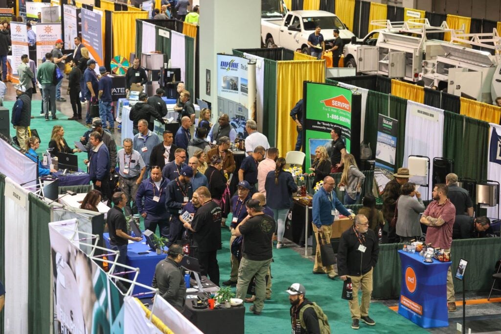 Busy expo floor with attendees visiting exhibitor booths and service displays at The Facilities Expo.