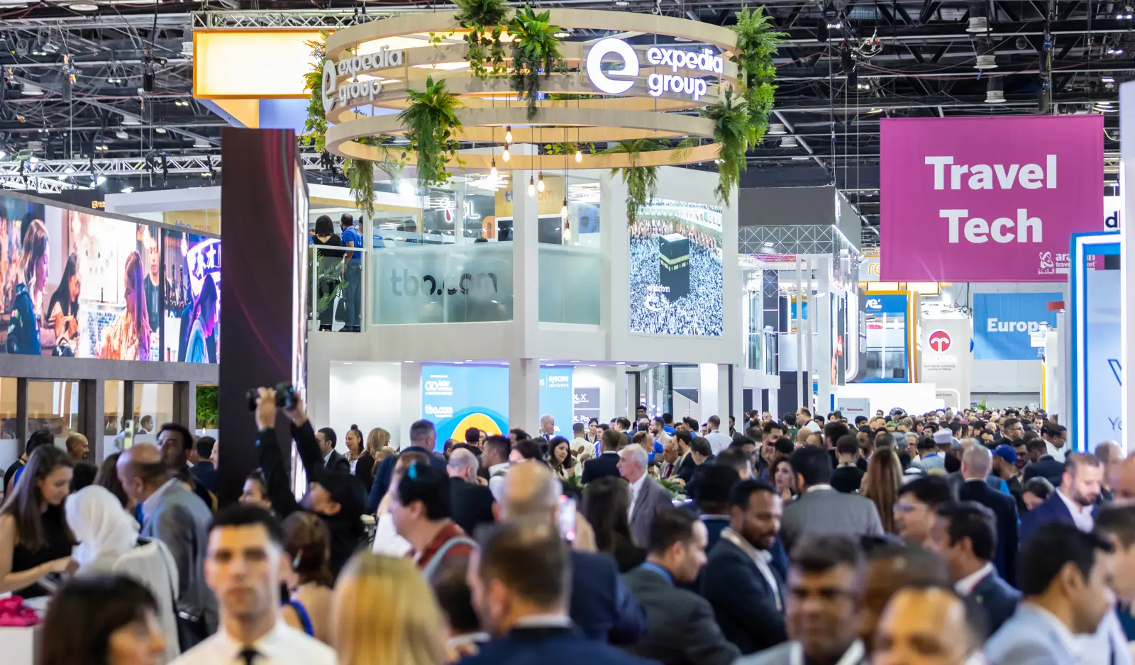 Busy exhibition floor at Arabian Travel Market with attendees networking around Dubai and travel industry booths