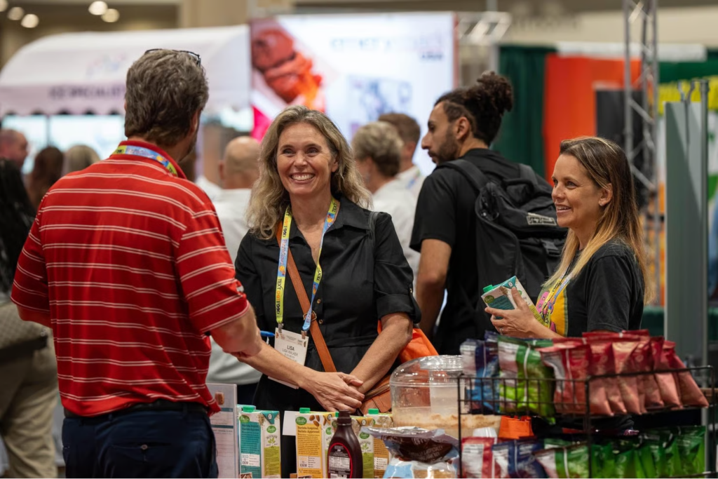Attendees networking with exhibitors at the International Restaurant and Foodservice Show of Florida