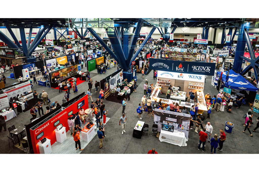 Aerial view of a busy trade show floor with vendor booths and attendees at Texas Restaurant Show